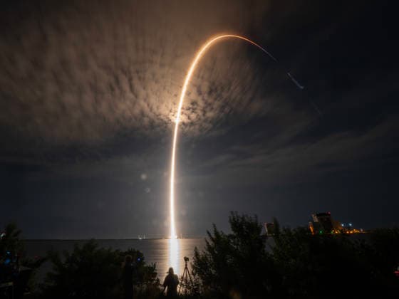 In a time exposure, SpaceX Falcon Heavy streaks into the clouds as it launches with classified NROL-97 national security payload for the National Reconnaissance Office (NTO) from LC-39A at Kennedy Space Center, Florida on October 1, 2026. NRO is America s spy satellite agency.  KSC2026100205 PATxBENIC