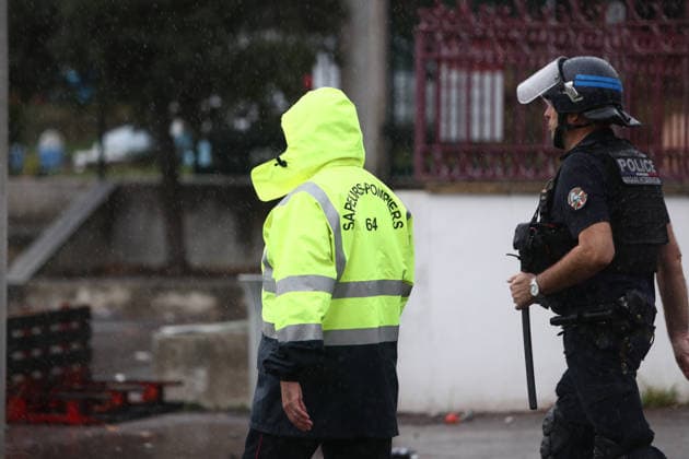October 1, 2026, Anglet, Nouvelle Aquitaine, France: A firefighter and a police officer walk together to assess the situation before extinguishing a fire during a protest outside the Lyco e Cantau in Anglet, southwestern France, on October 1, 2026, against overcrowded classes and a lack of resources. The movement, which began in the Paris region a week ago, has spread across France, with hundreds of high schools blocked. Anglet France - ZUMAb298 20261001_zsp_b298_009 Copyright: xJulesxBuonx
