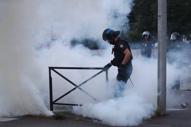 October 1, 2026, Anglet, Nouvelle Aquitaine, France: A police officer wearing a helmet and visor walks through tear gas as he tries to pick up an object during a protest outside the Lyco e Cantau in Anglet, southwestern France, on October 1, 2026, against overcrowded classes and a lack of resources. The movement, which began in the Paris region a week ago, has spread across France, with hundreds of high schools blocked. Anglet France  - ZUMAb298 20261001_zsp_b298_033 Copyright: xJulesxBuonx