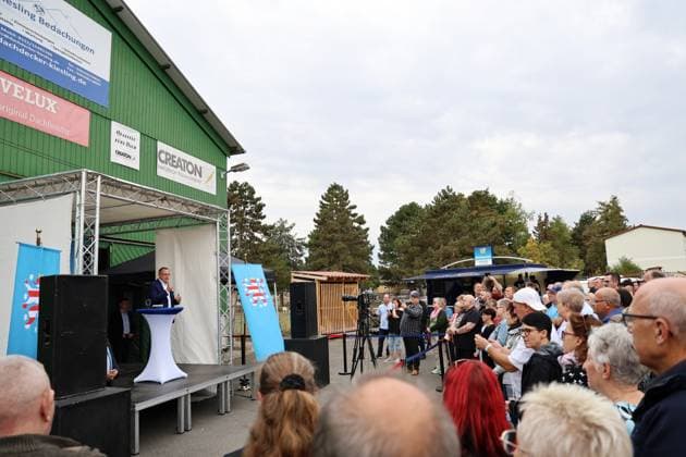 Enjoying a Bratwurst with Haseloff and Chrupalla, October 1, 2026, Doellstaedt, AfD event at Kiesling Roofing; enjoying a bratwurst with State Parliament Representative Daniel Haseloff (AfD) and AfD National Spokesperson Tino Chrupalla; pictured: Tino Chrupalla giving a speech on stage, with event attendees standing around the stage