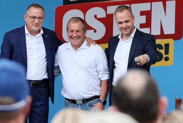 Over a bratwurst with Haseloff and Chrupalla, October 1, 2026, Doellstaedt, AfD event at Kiesling Roofing, Enjoying a bratwurst with State Parliament Member Daniel Haseloff (AfD) and AfD National Spokesperson Tino Chrupalla; pictured: Tino Chrupalla with Mark Kiesling, owner of Kiesling Roofing, and Daniel Haseloff (AfD) on stage; in the background i