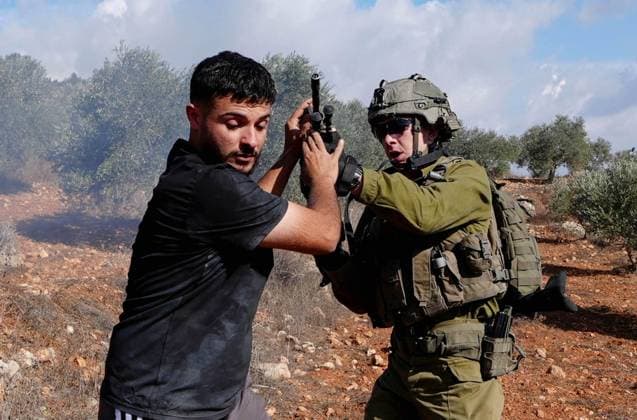 Israeli forces injure Palestinian farmer during raids on olive farms NABLUS, WEST BANK, PALESTINE - OCTOBER 2: Israeli military forces and settlers intervene against Palestinian farmers and international activists harvesting olives in the town of Beita, in Nablus, West Bank, Palestine on October 02, 2026. Israeli settlers beat the 46-year-old Palestinian man in the town of Beita, according to the Palestinian Red Crescent Society. Witnesses told Anadolu that a group of Israeli settlers fired stun grenades and tear gas at farmers in the Jabal al-Arma area, forcing them to leave. Issam Rimawi Anadolu Nablus West Bank. Editorial use only. Please get in touch for any other usage.  Copyright: x2026xAnadoluxIssamxRimawix