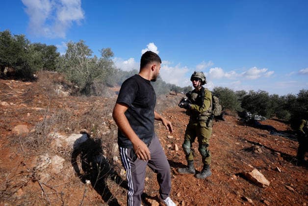 Israeli forces injure Palestinian farmer during raids on olive farms NABLUS, WEST BANK, PALESTINE - OCTOBER 2: Israeli military forces and settlers intervene against Palestinian farmers and international activists harvesting olives in the town of Beita, in Nablus, West Bank, Palestine on October 02, 2026. Israeli settlers beat the 46-year-old Palestinian man in the town of Beita, according to the Palestinian Red Crescent Society. Witnesses told Anadolu that a group of Israeli settlers fired stun grenades and tear gas at farmers in the Jabal al-Arma area, forcing them to leave. Issam Rimawi Anadolu Nablus West Bank. Editorial use only. Please get in touch for any other usage.  Copyright: x2026xAnadoluxIssamxRimawix
