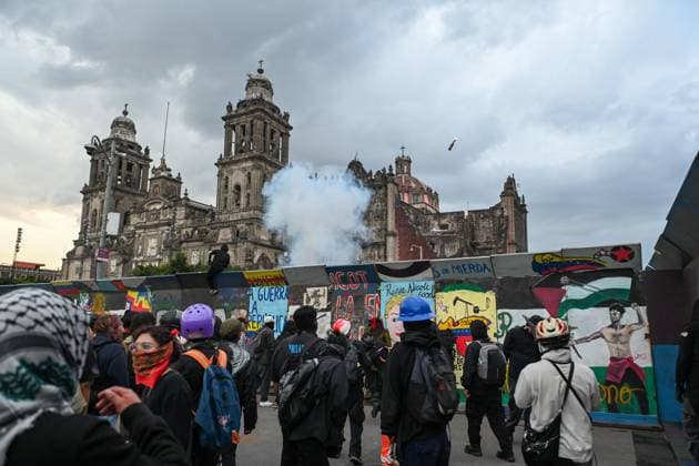 October 2, 2026: TO-45322-MEXICO , October 2, 2026. Student leaders from 1968 marched alongside students from various public universities, feminist collectives, "searching mothers," and Indigenous people from diverse regions to commemorate the anniversary of the Tlatelolco Massacre. They chanted slogans such as "No forgiveness, no forgetting," "Death to the State," and "It was the military." They marched along various avenues in the Mexican capital, concluding their rally at the Z& xf3;calo plaza, where clashes broke out with police stationed behind the barriers guarding the National Palace. In Mexico City. Clasos.com.mx - ZUMAcs4_ 20261002_faa_cs4_148 Copyright: xJavierxLiraxOterox