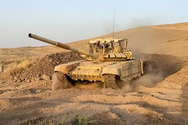 TAJIKISTAN - OCTOBER 3, 2026: Russian tank crews destroy a simulated enemy during the Tsentr Centre 2026 military exercise held at the Lyaur training ground. Video screen grab. Best quality available. Russian Defence Ministry TASS  98708961
