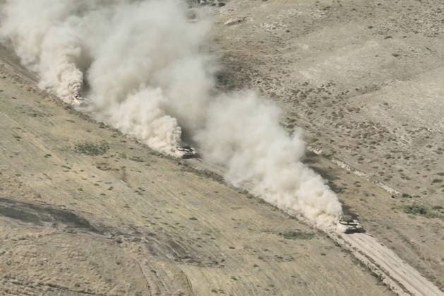 TAJIKISTAN - OCTOBER 3, 2026: Russian tank crews destroy a simulated enemy during the Tsentr Centre 2026 military exercise held at the Lyaur training ground. Video screen grab. Best quality available. Russian Defence Ministry TASS  98708975