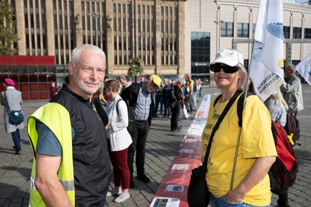 October 3, 2026 Press event: Es brennt initiative—human chain in Dortmund, Hansaplatz. Richard Stanek (left) believes it is important for many people to participate; Anne Bussmann (right). Fossil fuels must be phased out. Dortmund, Hansaplatz and Westenhellweg, North Rhine-Westphalia, Germany