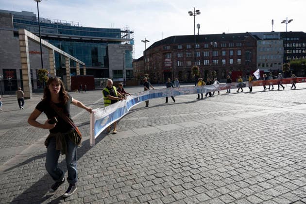 October 3, 2026 Press Event: Es brennt Initiative Human Chain in Dortmund, Hansaplatz Marching with the banner to Westenhellweg, Dortmund; Hansaplatz and Westenhellweg, North Rhine-Westphalia, Germany