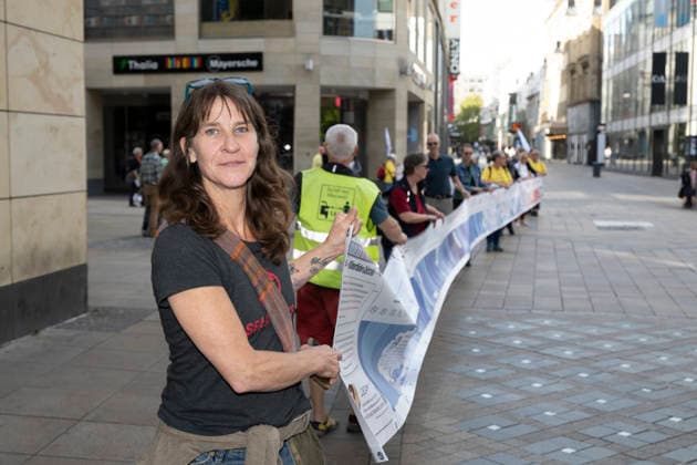 October 3, 2026 Press event: Es brennt initiative—human chain in Dortmund, Hansaplatz; Sylvia Jost supports Xr and leads the banner; Dortmund, Hansaplatz and Westenhellweg, North Rhine-Westphalia, Germany
