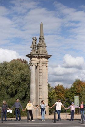 Protesters during a human chain for climate protection and democracy on the Glienicker Bridge in Potsdam, October 3, 2026. It s on fire —human chain in Potsdam