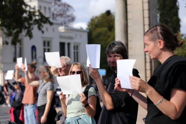 Protesters during a human chain for climate protection and democracy on the Glienicker Bridge in Potsdam, October 3, 2026. It s on fire —human chain in Potsdam