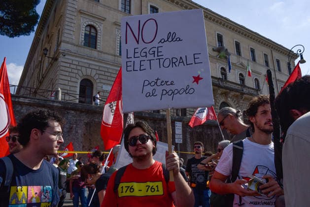 October 3, 2026, Rome, Rome, Italy: A protester holds a sign against the electoral law during the Potere al Popolo demonstration at Piazza Bocca della Verità in Rome on October 3, 2026. Rome Italy - ZUMAn299 20261003_zip_n299_005 Copyright: xVincenzoxNuzzolesex