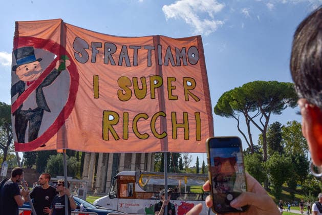 October 3, 2026, Rome, Rome, Italy: Demonstrators hold a banner calling to evict the super-rich during the Potere al Popolo demonstration at Piazza Bocca della Verità in Rome on October 3, 2026. Rome Italy - ZUMAn299 20261003_zip_n299_002 Copyright: xVincenzoxNuzzolesex