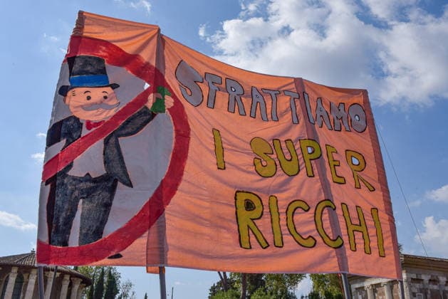 October 3, 2026, Rome, Rome, Italy: Demonstrators hold a banner calling to evict the super-rich during the Potere al Popolo demonstration at Piazza Bocca della Verità in Rome on October 3, 2026. Rome Italy - ZUMAn299 20261003_zip_n299_001 Copyright: xVincenzoxNuzzolesex