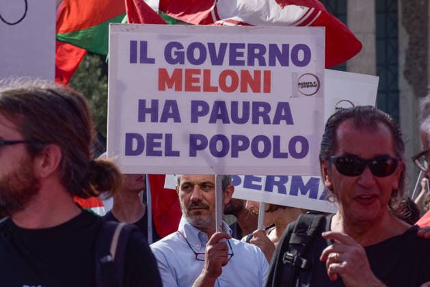 October 3, 2026, Rome, Rome, Italy: A protester holds a sign against the policies of the Meloni government during the Potere al Popolo demonstration at Piazza Bocca della Verità in Rome on October 3, 2026. Rome Italy - ZUMAn299 20261003_zip_n299_004 Copyright: xVincenzoxNuzzolesex