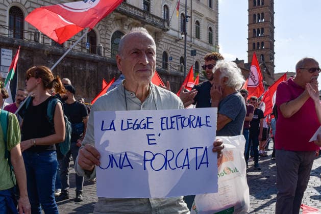 October 3, 2026, Rome, Rome, Italy: A protester holds a sign against the electoral law during the Potere al Popolo demonstration at Piazza Bocca della Verità in Rome on October 3, 2026. Rome Italy - ZUMAn299 20261003_zip_n299_007 Copyright: xVincenzoxNuzzolesex