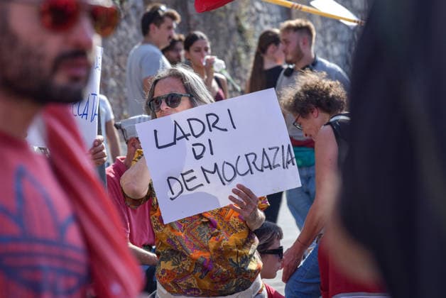 October 3, 2026, Rome, Rome, Italy: A protester holds a sign against the electoral law during the Potere al Popolo demonstration at Piazza Bocca della Verità in Rome on October 3, 2026. Rome Italy - ZUMAn299 20261003_zip_n299_013 Copyright: xVincenzoxNuzzolesex