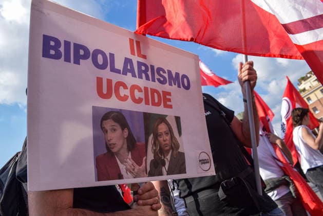 October 3, 2026, Rome, Rome, Italy: A protester holds a sign against political bipolarism during the Potere al Popolo demonstration at Piazza Bocca della Verità in Rome on October 3, 2026. Rome Italy - ZUMAn299 20261003_zip_n299_016 Copyright: xVincenzoxNuzzolesex