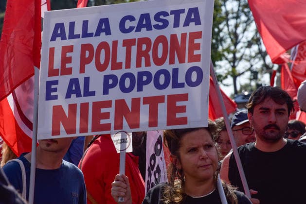 October 3, 2026, Rome, Rome, Italy: A protester holds a sign against the policies of the Meloni government during the Potere al Popolo demonstration at Piazza Bocca della Verità in Rome on October 3, 2026. Rome Italy - ZUMAn299 20261003_zip_n299_017 Copyright: xVincenzoxNuzzolesex