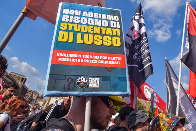October 3, 2026, Rome, Rome, Italy: A protester holds a sign against luxury student housing during the Potere al Popolo demonstration at Piazza Bocca della Verità in Rome on October 3, 2026. Rome Italy - ZUMAn299 20261003_zip_n299_023 Copyright: xVincenzoxNuzzolesex