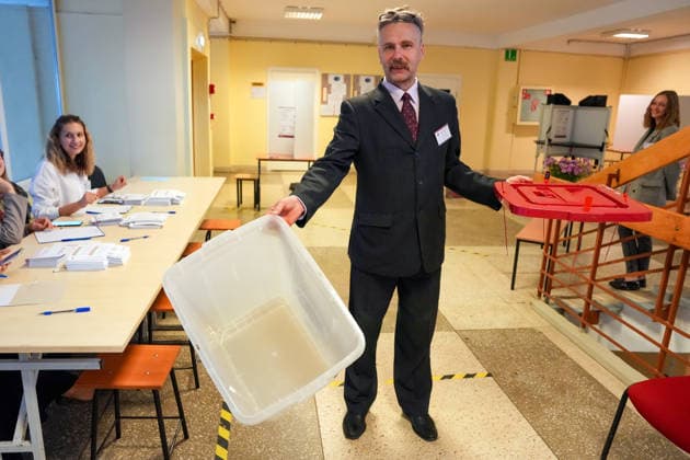 October 3, 2026, Riga, LATVIA: A man demonstrates an empty ballot box at a polling station during the parliamentary elections in Riga, Latvia, Oct. 3, 2026. Riga LATVIA - ZUMAp305 20261003_zip_p305_003 Copyright: xEdijsxPalensx