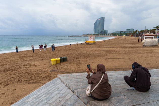Red alert for extreme weather in Barcelona, Spain. Locals and tourists take photos of the storm from the promenade and the sand at Sant Sebastià Beach during red alert for extreme weather in Promenade, Barcelona, Spain, on October 3, 2026. Barcelona Promenade Barcelona Spain