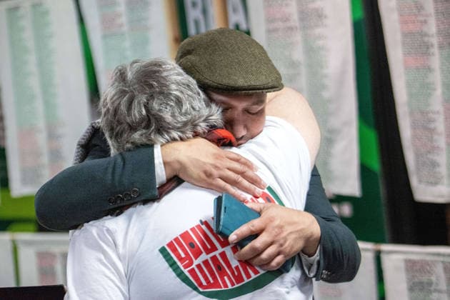 October 3, 2026, Brighton, United Kingdom: Green Party Deputy Leader Mothin Ali embraces a conference attendee in front of the Stitch Their Names Together memorial exhibition at the Brighton Centre. The large-scale textile installation, on display during the party s autumn conference, features thousands of hand-stitched names of individuals and families killed in Gaza since 2023. Brighton United Kingdom - ZUMAs197 20261003_aab_s197_003 Copyright: xGaryxRobertsx