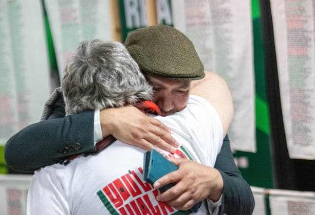 October 3, 2026, Brighton, United Kingdom: Green Party Deputy Leader Mothin Ali embraces a conference attendee in front of the Stitch Their Names Together memorial exhibition at the Brighton Centre. The large-scale textile installation, on display during the party s autumn conference, features thousands of hand-stitched names of individuals and families killed in Gaza since 2023. Brighton United Kingdom - ZUMAs197 20261003_aab_s197_004 Copyright: xGaryxRobertsx