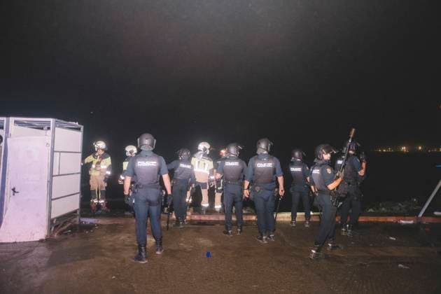 October 3, 2026, Ceuta, Ceuta, Spain: Riot police officers and firefighters line up next to the portable toilets of a makeshift migrant camp in Ceuta at night. Riot police escorted firefighters through the camp on the night of October 3 to put out the fires that people living there use to cook their food. Thousands of migrants, most of them young Moroccan men, have been living in makeshift settlements in the Spanish North African enclave of Ceuta since a mass arrival at the end of July 2026 set off a migration and political crisis. Ceuta Spain  - ZUMAs392 20261003_zip_s392_020 Copyright: xFabianxSuspensivox