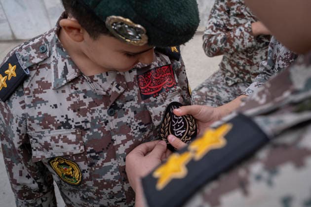 Opening Ceremony Of Second City-Square Military Training Camp An Iranian schoolboy wearing an Iranian Army military uniform helps his friend attach a badge for self-sacrificing forces as they prepare to take part in the opening ceremony of the second city-square military training camp in downtown Tehran, Iran, on October 3, 2026. The second City-Square Military Training Camp for the self-sacrificing forces was established by the Basij paramilitary force, with personnel from the Islamic Republic of Iran Army responsible for training the volunteers. Tehran Tehran Iran  Copyright: xMortezaxNikoubazlx originalFilename: nikoubazl-openingc261003_npccq.jpg