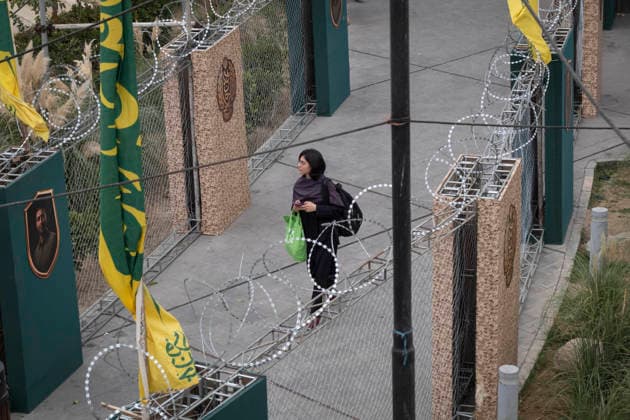 Daily Life Around A City-Square Military Training Camps A young Iranian woman walks past the second city-square military training camp for self-sacrificing forces in downtown Tehran, Iran, on October 3, 2026. The camp was established by the Basij paramilitary force, with personnel from the Islamic Republic of Iran Army responsible for training the volunteers. Tehran Tehran Iran  Copyright: xMortezaxNikoubazlx originalFilename: nikoubazl-dailylif261003_npEhM