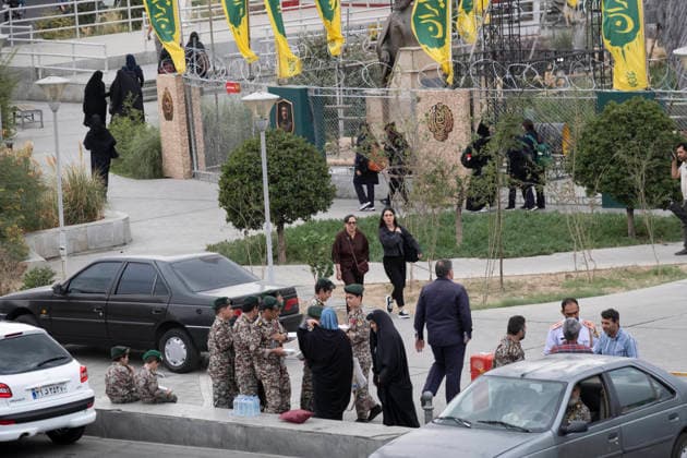 Daily Life Around A City-Square Military Training Camps Two young Iranian women walk past schoolboys wearing Iranian Army military uniforms outside the second city-square military training camp for self-sacrificing forces in downtown Tehran, Iran, on October 3, 2026. The camp was established by the Basij paramilitary force, with personnel from the Islamic Republic of Iran Army responsible for training the volunteers. Tehran Tehran Iran  Copyright: xMortezaxNikoubazlx originalFilename: nikoubazl-dailylif261003_npVnv