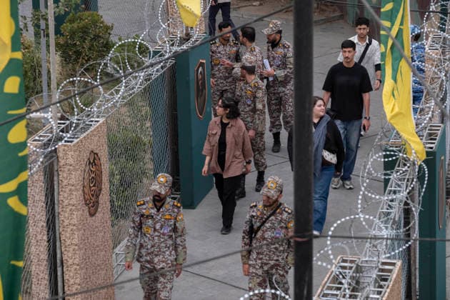 Daily Life Around A City-Square Military Training Camps Two young Iranian women walk past the second city-square military training camp for self-sacrificing forces in downtown Tehran, Iran, on October 3, 2026. The camp was established by the Basij paramilitary force, with personnel from the Islamic Republic of Iran Army responsible for training the volunteers. Tehran Tehran Iran  Copyright: xMortezaxNikoubazlx originalFilename: nikoubazl-dailylif261003_npw20