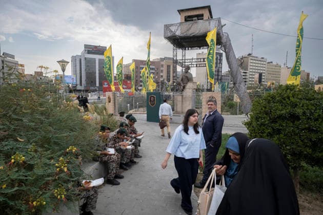 Daily Life Around A City-Square Military Training Camps A young Iranian woman walks past schoolboys wearing Iranian Army military uniforms outside the second city-square military training camp for self-sacrificing forces in downtown Tehran, Iran, on October 3, 2026. The camp was established by the Basij paramilitary force, with personnel from the Islamic Republic of Iran Army responsible for training the volunteers. Tehran Tehran Iran  Copyright: xMortezaxNikoubazlx originalFilename: nikoubazl-dailylif261003_npzGJ