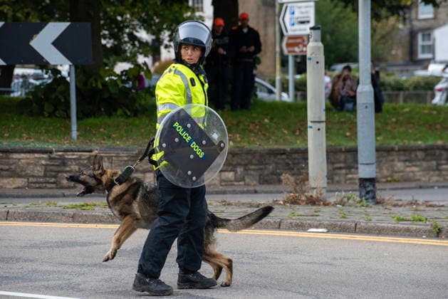 October 3, 2026, Dover, United Kingdom: A member of the police dog unit with her German Shepherd during a demonstration in Dover. Supporters of the English Defence League (EDL) gathered in Dover, UK to march through the town all the way to the harbour. English Defence League is an extreme far-right and Islamophobic organisation. It was founded by Tommy Robinson (pseudonym of Steven Yaxley-Lennon) in 2009. Dover United Kingdom - ZUMAs197 20261003_aaa_s197_250 Copyright: xKrisztianxElekx