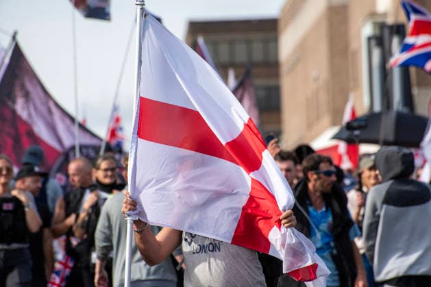 October 3, 2026, Dover, United Kingdom: A far-right protester holds a St George s flag during a protest in Dover. Supporters of the English Defence League (EDL) gathered in Dover, UK to march through the town all the way to the harbour. English Defence League is an extreme far-right and Islamophobic organisation. It was founded by Tommy Robinson (pseudonym of Steven Yaxley-Lennon) in 2009. Dover United Kingdom - ZUMAs197 20261003_aaa_s197_254 Copyright: xKrisztianxElekx