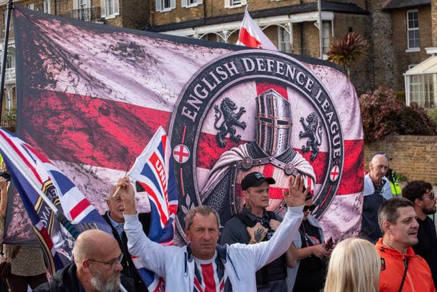 October 3, 2026, Dover, United Kingdom: Far-right protesters march with banner and flags to the harbour during a demonstration in Dover. Supporters of the English Defence League (EDL) gathered in Dover, UK to march through the town all the way to the harbour. English Defence League is an extreme far-right and Islamophobic organisation. It was founded by Tommy Robinson (pseudonym of Steven Yaxley-Lennon) in 2009. Dover United Kingdom  - ZUMAs197 20261003_aaa_s197_260 Copyright: xKrisztianxElekx