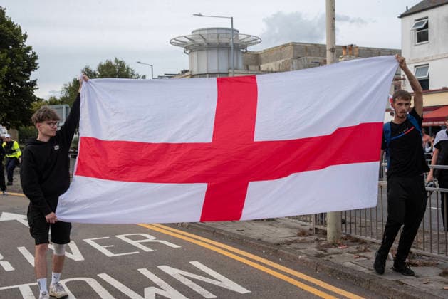 October 3, 2026, Dover, United Kingdom: Far-right protesters hold a St George s flag during a demonstration in Dover. Supporters of the English Defence League (EDL) gathered in Dover, UK to march through the town all the way to the harbour. English Defence League is an extreme far-right and Islamophobic organisation. It was founded by Tommy Robinson (pseudonym of Steven Yaxley-Lennon) in 2009. Dover United Kingdom  - ZUMAs197 20261003_aaa_s197_263 Copyright: xKrisztianxElekx