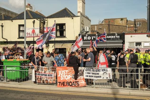 October 3, 2026, Dover, United Kingdom of Great Britain and Northern Ireland: DOVER, UNITED KINGDOM, OCTOBER 3, 2026: Anti-immigration protesters and anti-racism counter-protesters gather during rival demonstrations in Dover, Kent. Anti-immigration demonstrators carrying Union flags and St George s flags displayed banners calling for deportations and an end to small-boat crossings, while counter-protesters gathered nearby. Police maintained a significant presence between the groups and monitored the demonstrations. Dover United Kingdom of Great Britain and Northern Ireland  - ZUMAq101 20261003_zna_q101_206 Copyright: xMarcxLewisx