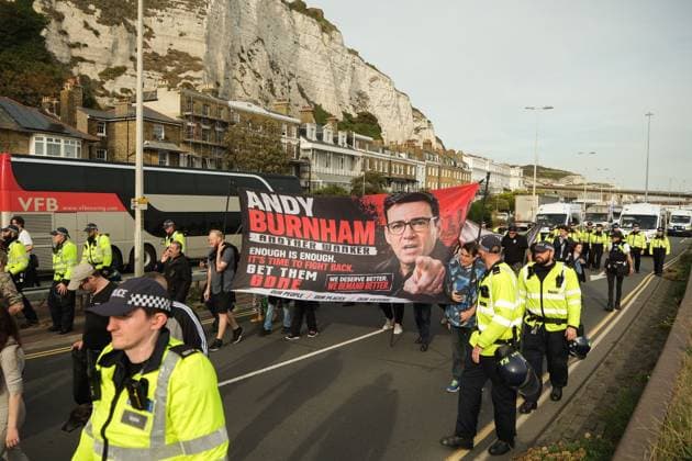October 3, 2026, Dover, United Kingdom of Great Britain and Northern Ireland: DOVER, UNITED KINGDOM, OCTOBER 3, 2026: Anti-immigration protesters and anti-racism counter-protesters gather during rival demonstrations in Dover, Kent. Anti-immigration demonstrators carrying Union flags and St George s flags displayed banners calling for deportations and an end to small-boat crossings, while counter-protesters gathered nearby. Police maintained a significant presence between the groups and monitored the demonstrations. Dover United Kingdom of Great Britain and Northern Ireland  - ZUMAq101 20261003_zna_q101_210 Copyright: xMarcxLewisx