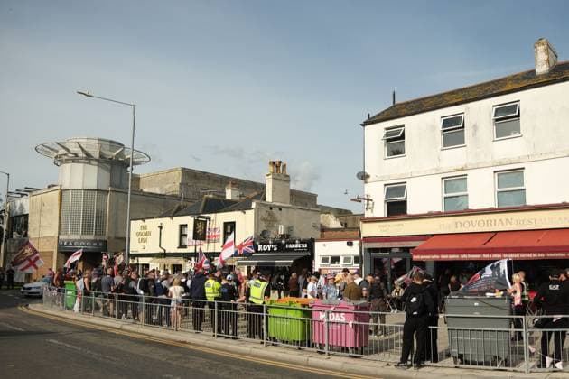 October 3, 2026, Dover, United Kingdom of Great Britain and Northern Ireland: DOVER, UNITED KINGDOM, OCTOBER 3, 2026: Anti-immigration protesters and anti-racism counter-protesters gather during rival demonstrations in Dover, Kent. Anti-immigration demonstrators carrying Union flags and St George s flags displayed banners calling for deportations and an end to small-boat crossings, while counter-protesters gathered nearby. Police maintained a significant presence between the groups and monitored the demonstrations. Dover United Kingdom of Great Britain and Northern Ireland  - ZUMAq101 20261003_zna_q101_211 Copyright: xMarcxLewisx