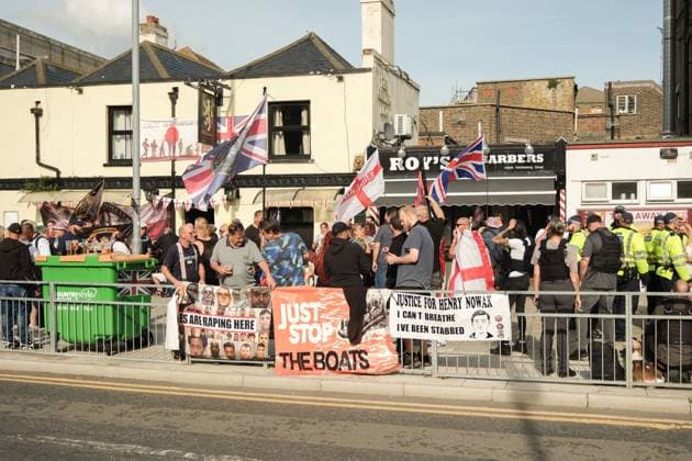 October 3, 2026, Dover, United Kingdom of Great Britain and Northern Ireland: DOVER, UNITED KINGDOM, OCTOBER 3, 2026: Anti-immigration protesters and anti-racism counter-protesters gather during rival demonstrations in Dover, Kent. Anti-immigration demonstrators carrying Union flags and St George s flags displayed banners calling for deportations and an end to small-boat crossings, while counter-protesters gathered nearby. Police maintained a significant presence between the groups and monitored the demonstrations. Dover United Kingdom of Great Britain and Northern Ireland  - ZUMAq101 20261003_zna_q101_212 Copyright: xMarcxLewisx