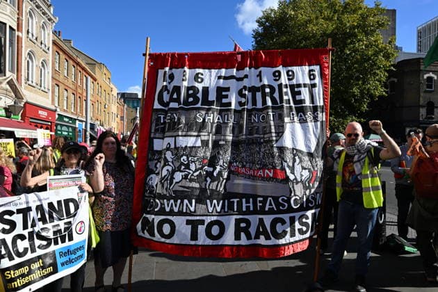 October 4, 2026, London, London, UK: London, UK. Demonstators take part in a march and rally organist by Unite The Union to mark the 90th anniversary of The Battle of Cable Street in the East End of London. All over the country in 1936, Mosley s British Union of Fascists were chased off the streets by a strong working class who knew that the politics of hate and division offers no solutions. The Battle of Cable Street on 4 October 1936 was by far the countryÃ¢â‚¬â ¢s biggest mobilisation against fascism. London UK  - ZUMAl94_ 20261004_zaf_l94_031 Copyright: xRayxTangx