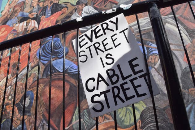 October 4, 2026, London, England, United Kingdom: Protesters leave a placard next to the Cable Street Mural, painted by Dave Binnington, Paul Butler, Ray Walker and Desmond Rochfort between 1979 and 1983, during the march against racism and fascism, marking the 90th anniversary since the Battle of Cable Street. London United Kingdom  - ZUMAv130 20261004_zip_v130_063 Copyright: xVukxValcicx