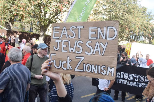 October 4, 2026, London, England, United Kingdom: A protester makes her feelings known about Zionism during the march against racism and fascism, marking the 90th anniversary since the Battle of Cable Street. London United Kingdom - ZUMAv130 20261004_zip_v130_072 Copyright: xVukxValcicx