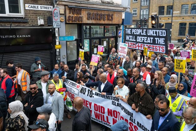 October 4, 2026, London, United Kingdom: Protesters hold a banner during the demonstration. Thousands of people gathered in East London for a march marking the 90th anniversary of the Battle of Cable Street. Participants met outside Tower Hamlets Town Hall before marching to commemorate the 1936 mobilisation against Oswald Mosley™s British Union of Fascists, when Jewish residents and their allies opposed a planned fascist march through the East End. London United Kingdom  - ZUMAs197 20261004_aaa_s197_142 Copyright: xAndreaxDomeniconix