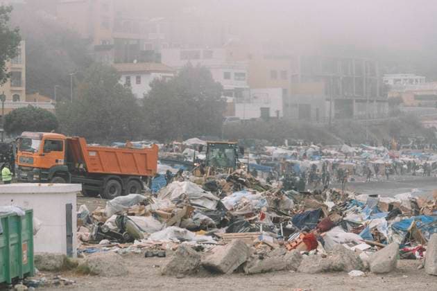 October 4, 2026, Ceuta, Ceuta, Spain: A dump truck next to a pile of debris from the dismantled shelters during the eviction of the makeshift migrant camp on El Trampolin beach in Ceuta. Spanish National Police began evicting the makeshift camp on El Trampolin beach in Ceuta on October 4, where more than 3,000 migrants, most of them young Moroccan men, were living. Dozens of police vans, armoured vehicles of the Police Intervention Units (UIP), drones and boats took part in the operation. People were taken by bus to the temporary centre at the Tarajal border to be identified, and the authorities plan to clear the beach in phases before October 15. The camp grew after a mass arrival at the end of July 2026 set off a migration and political c - ZUMAs392 20261004_zip_s392_029 Copyright: xFabianxSuspensivox