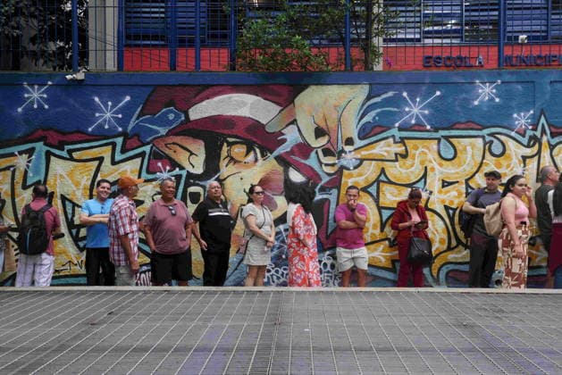 October 4, 2026, Rio De Janeiro, Rio De Janeiro, Brazil: Voters wait in line outside Escola Municipal MaroÂ­lia de Dirceu, a polling place in Brazil on Election Day as millions of citizens head to the polls in the countryÃ¢â‚¬â ¢s closely contested 2026 general election. The presidential race between incumbent Luiz InoÂ¡cio Lula da Silva and right-wing Senator FloÂ¡vio Bolsonaro has dominated the campaign, with polls showing a tight contest ahead of the October 4 first round. Brazilians are also voting for governors, senators and federal and state legislators. Rio De Janeiro Brazil - ZUMAn Li 20261004_znp_k251_006 Copyright: xBobxKarpx