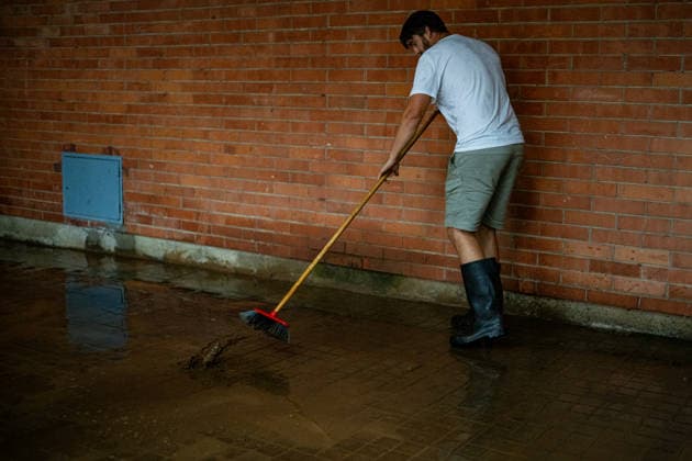 Heavy rains in Catalonia cause widespread disruption. A person cleans up a flooded street in the Nou Barris neighborhood on October 5, 2026, in Barcelona, Catalonia, Spain. Rain and storms will once again dominate the day on Monday, though with less intensity than over the weekend, with yellow and orange alerts in effect at times in some areas of the country, and even a red alert remaining in effect until 10 a.m. in Barcelona, with cumulative rainfall of 90 l m². OCTOBER 5, 2026 Lorena Sopê Barcelona, Catalonia, Spain  Copyright: xLorenaxSopÃªnax 7822403