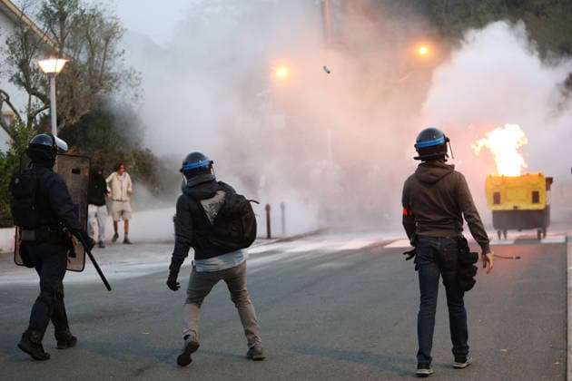 October 5, 2026, Anglet, Nouvelle Aquitaine, France: A plainclothes police officer from the anti-crime brigade (BAC) throws a tear gas canister towards youths during a protest by high school students against the government outside the Cantau high school in Anglet, southwestern France, on October 5, 2026. Students have been blocking schools across France since September 21 to demand more teachers, smaller classes and better school buildings. Cantau was closed by authorities after clashes in recent days. Anglet France - ZUMAb298 20261005_zsp_b298_002 Copyright: xJulesxBuonx